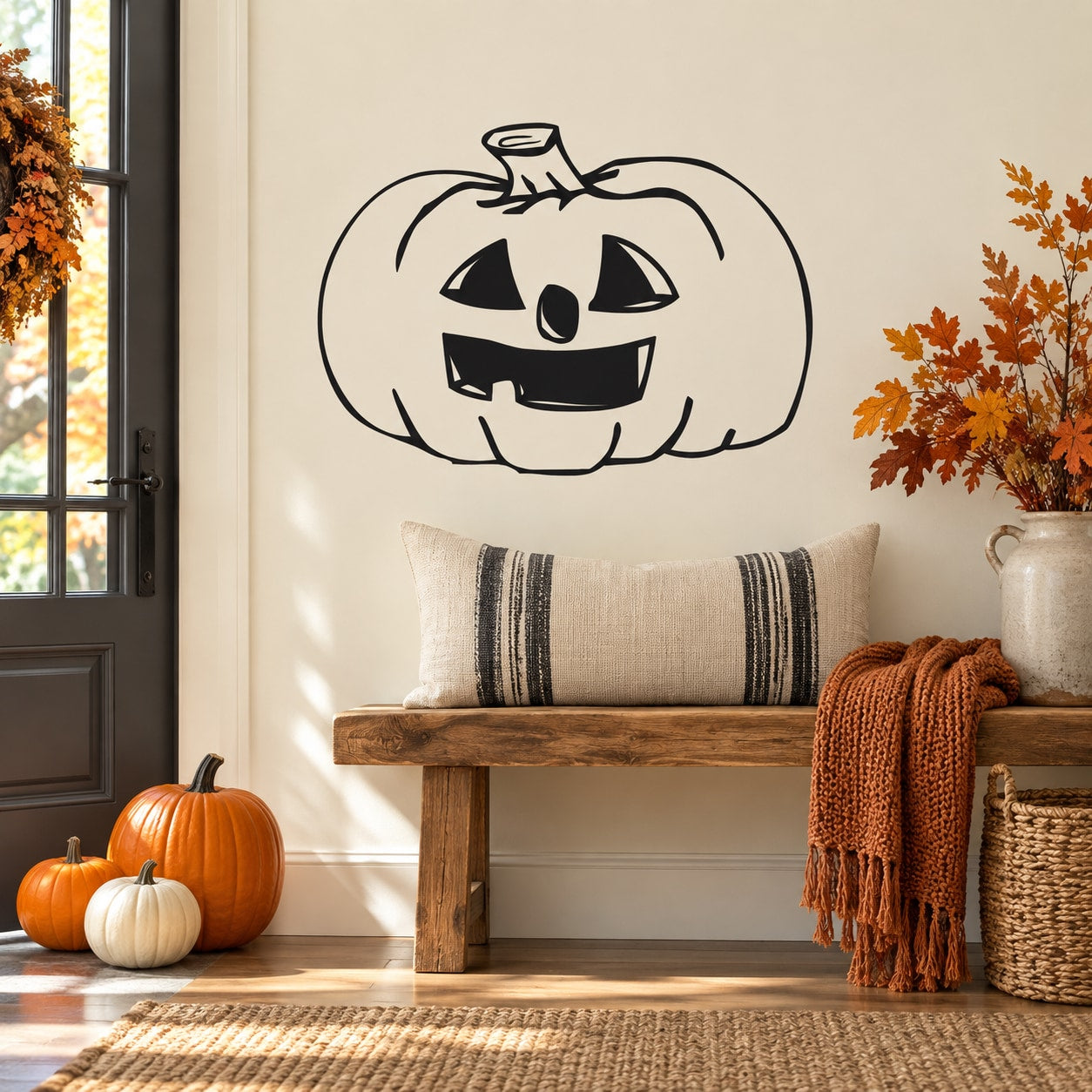 Halloween jack-o-lantern face decal with black outline on light wall.