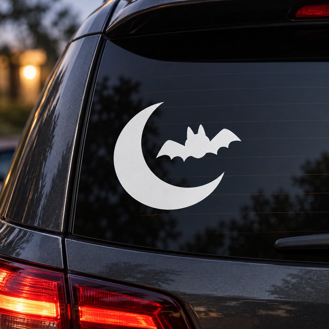 White bat and crescent moon car decal on rear window