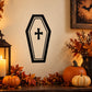 Black and white coffin-shaped light decal with a cross symbol