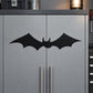 Black bat wall decal with symmetrical wings on gray cabinet door