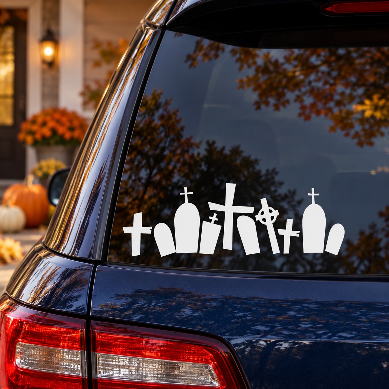 Graveyard decal with white gravestones and cross symbols on a car window