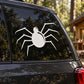 Round spider decal with white circular body and long legs on car window