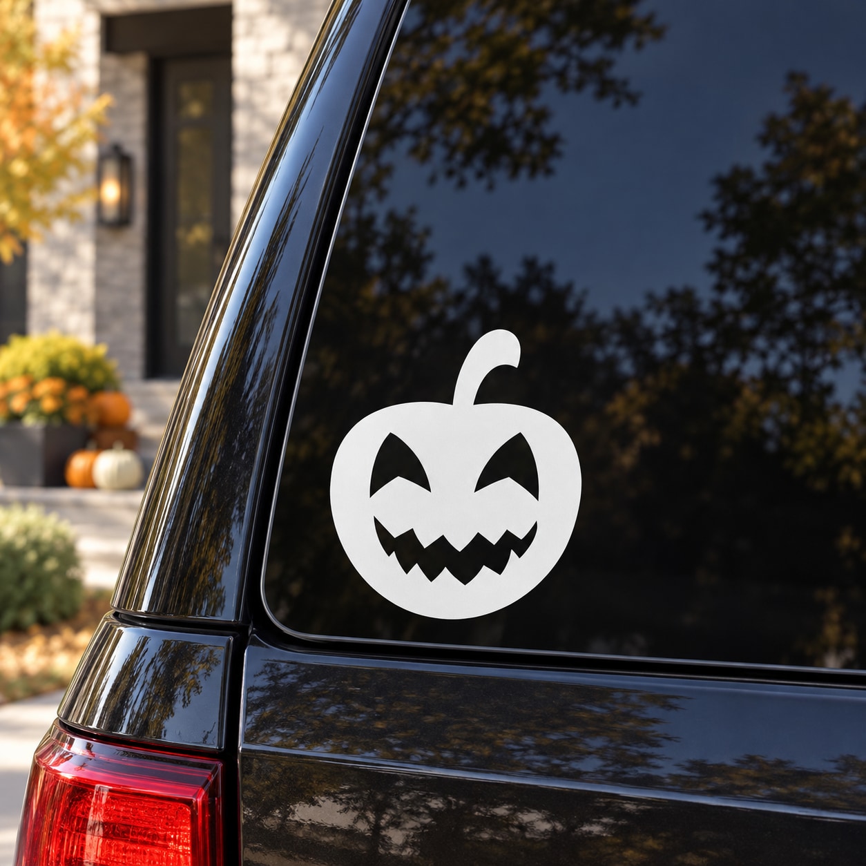 Jack-o-lantern decal: white carved pumpkin smile face on car window