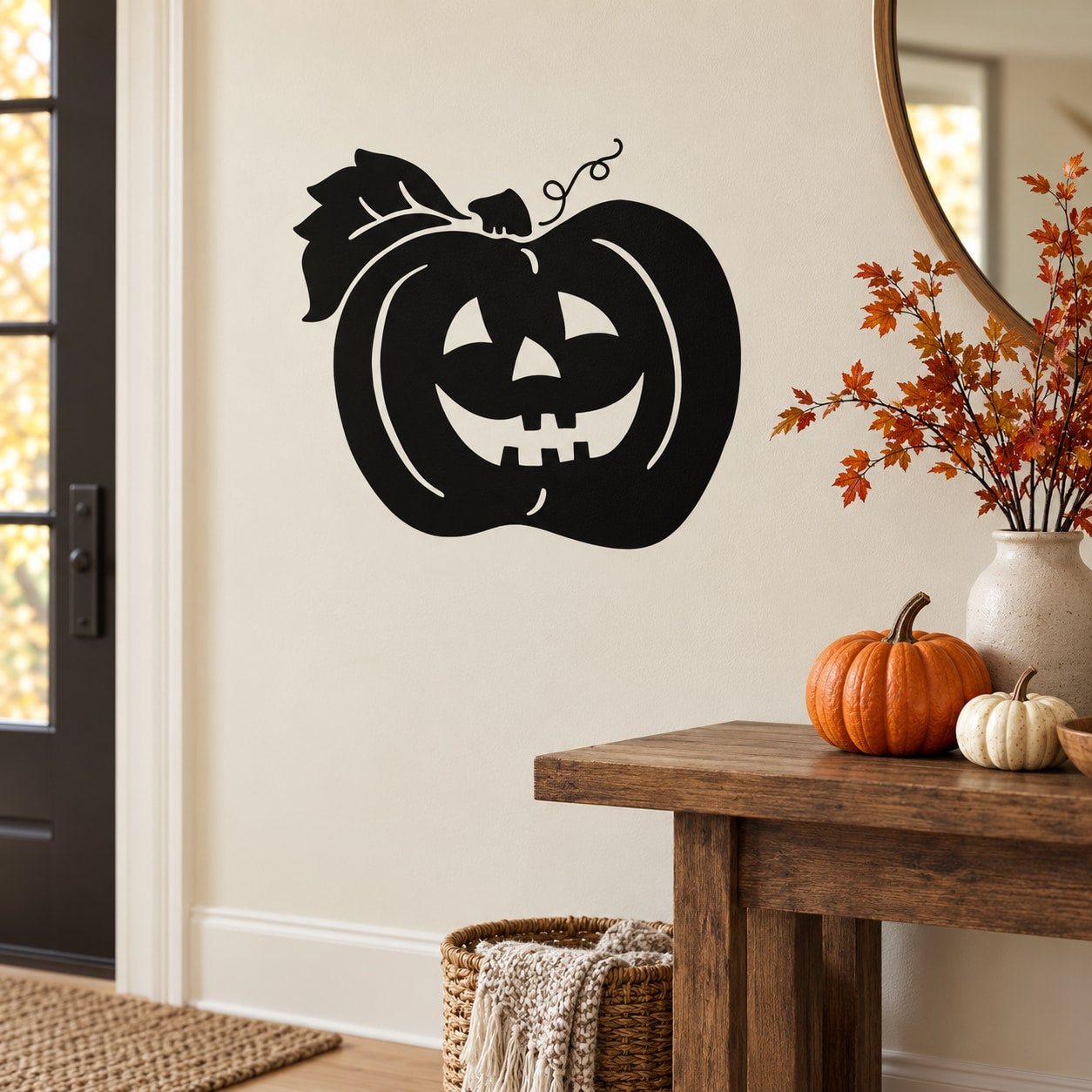 Black laughing jack-o-lantern decal with leaf details on wall