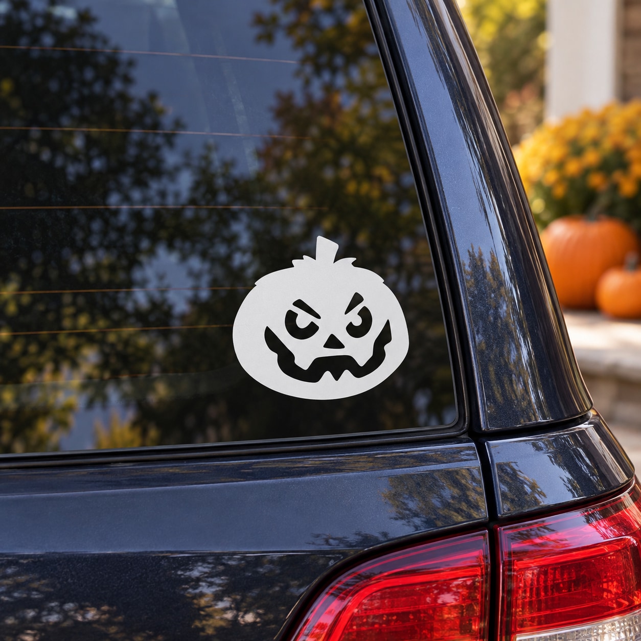 Angry jack-o-lantern decal: white circle with black scary face on vehicle window