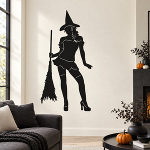 Black witch holding broom silhouette wall decal in a standing pose
