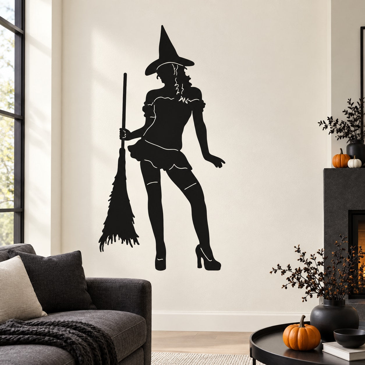 Black witch holding broom silhouette wall decal in a standing pose