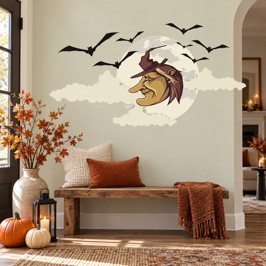Halloween sticker of a witch face on a full moon with flying bat silhouettes