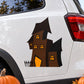 Die-cut haunted house decal with black silhouette and glowing window details