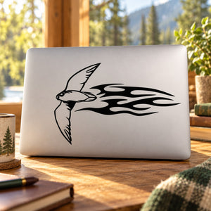 Soaring hawk fire-style decal with black outline and flame-like tail on light surface