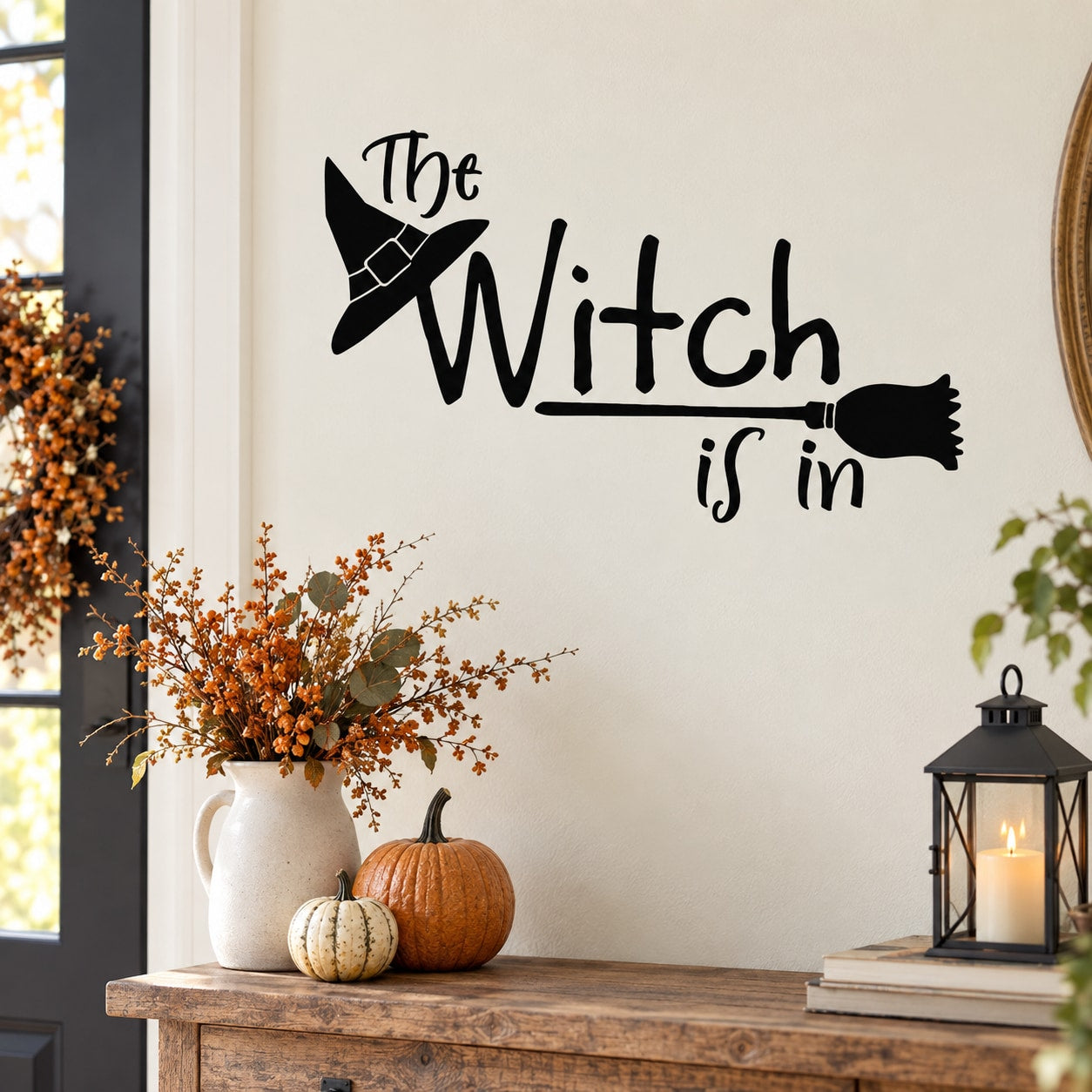 Black wall decal: 'The Witch is In' text with witch hat and broom