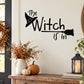 Black wall decal: 'The Witch is In' text with witch hat and broom