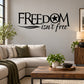 Wall decal with bold black “FREEDOM isn’t free” lettering and a star inside the O