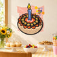 Birthday cupcake sticker with candle and flame, pink confetti burst background