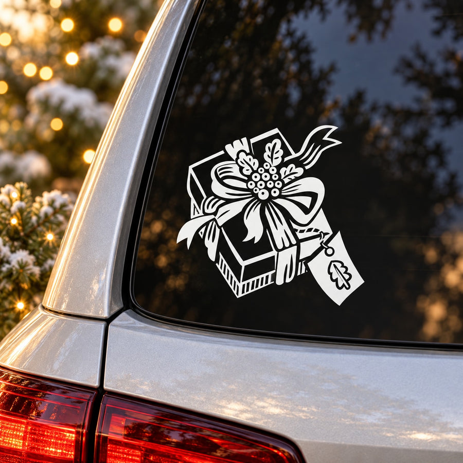 White present gift box decal with ribbon and bow on black car window
