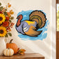 Thanksgiving turkey resting cartoon sticker, brown and gray turkey in blue wave circle