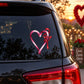Candy-striped heart loop sticker with red bow on car window