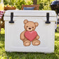 Valentine teddy bear sticker with plush bear holding a pink heart on white surface