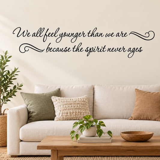 Cursive wall quote decal: “We all feel younger than we are” and “the spirit never ages”