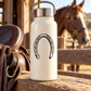 Horseshoe decal with black outline design on a white bottle