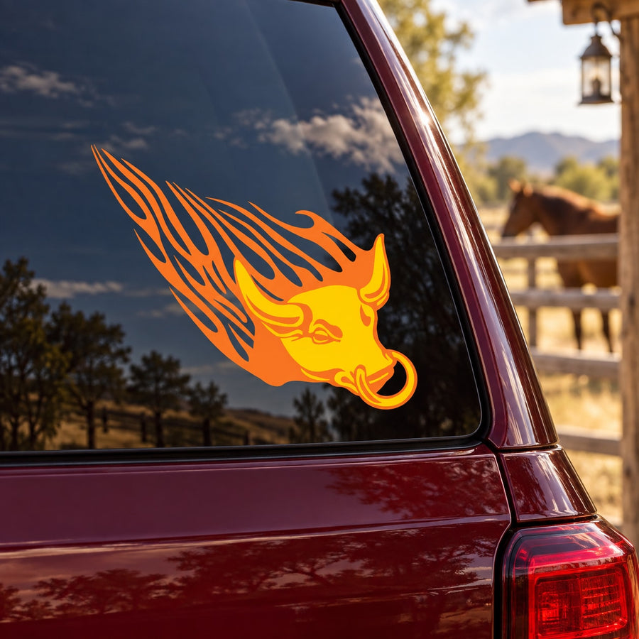 Flame bull head sticker with orange and yellow fire graphic on car window