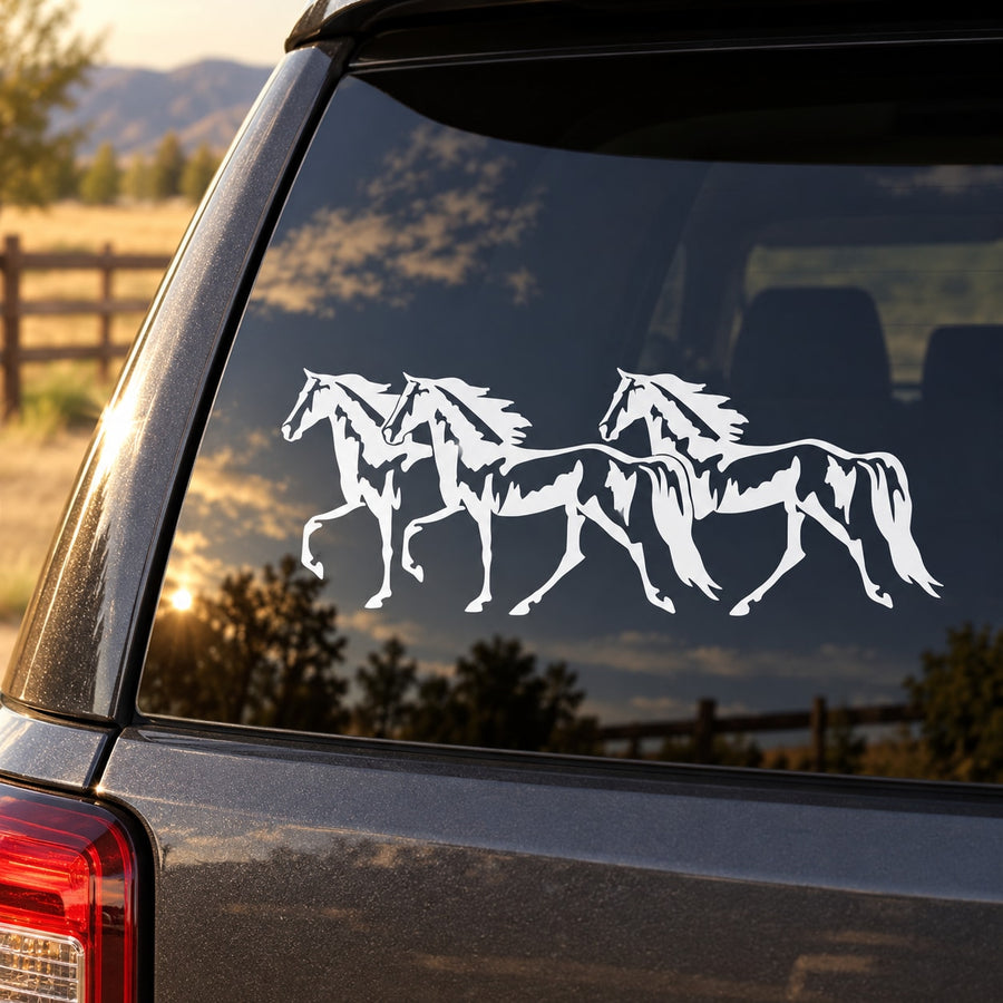 White three-horse walking decal on dark car rear window