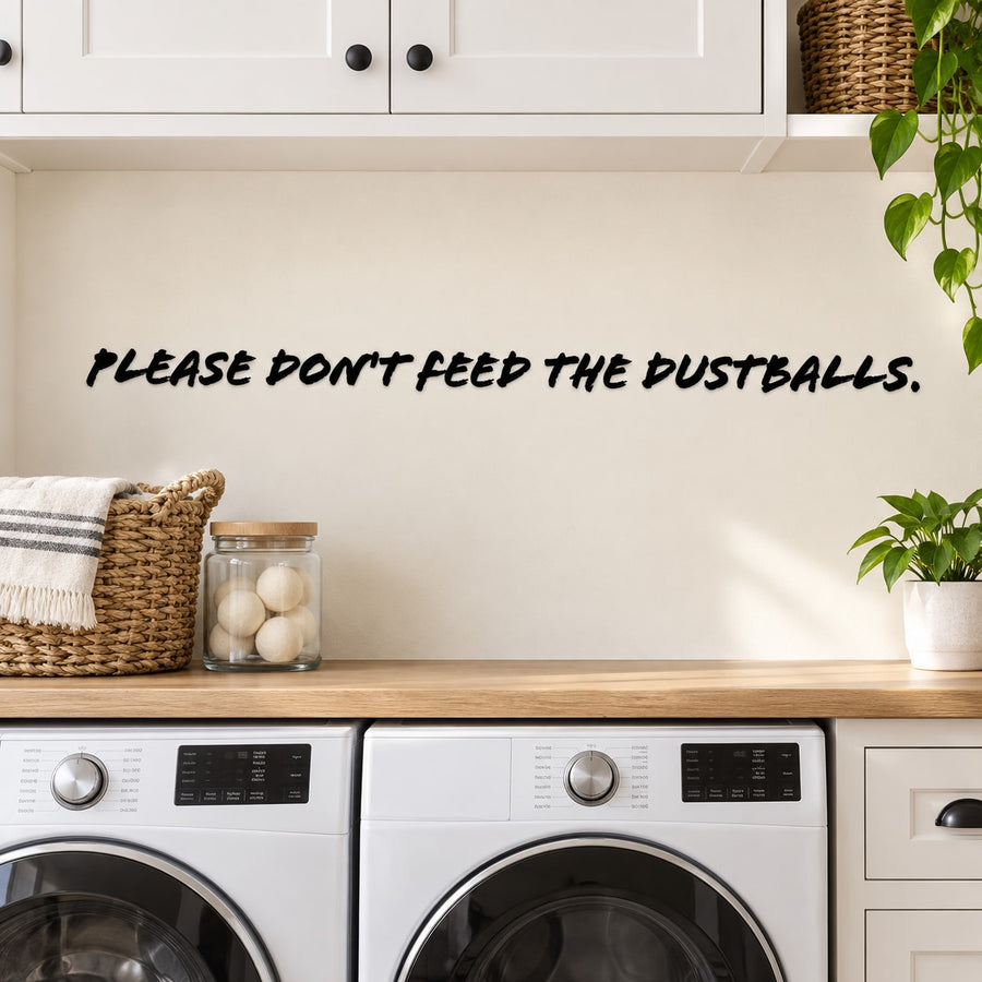 Wall decal with black quote text: “PLEASE DON’T FEED THE DUSTBALLS.”