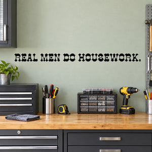 Wall decal with bold black text: "REAL MEN DO HOUSEWORK."