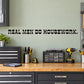 Wall decal with bold black text: "REAL MEN DO HOUSEWORK."