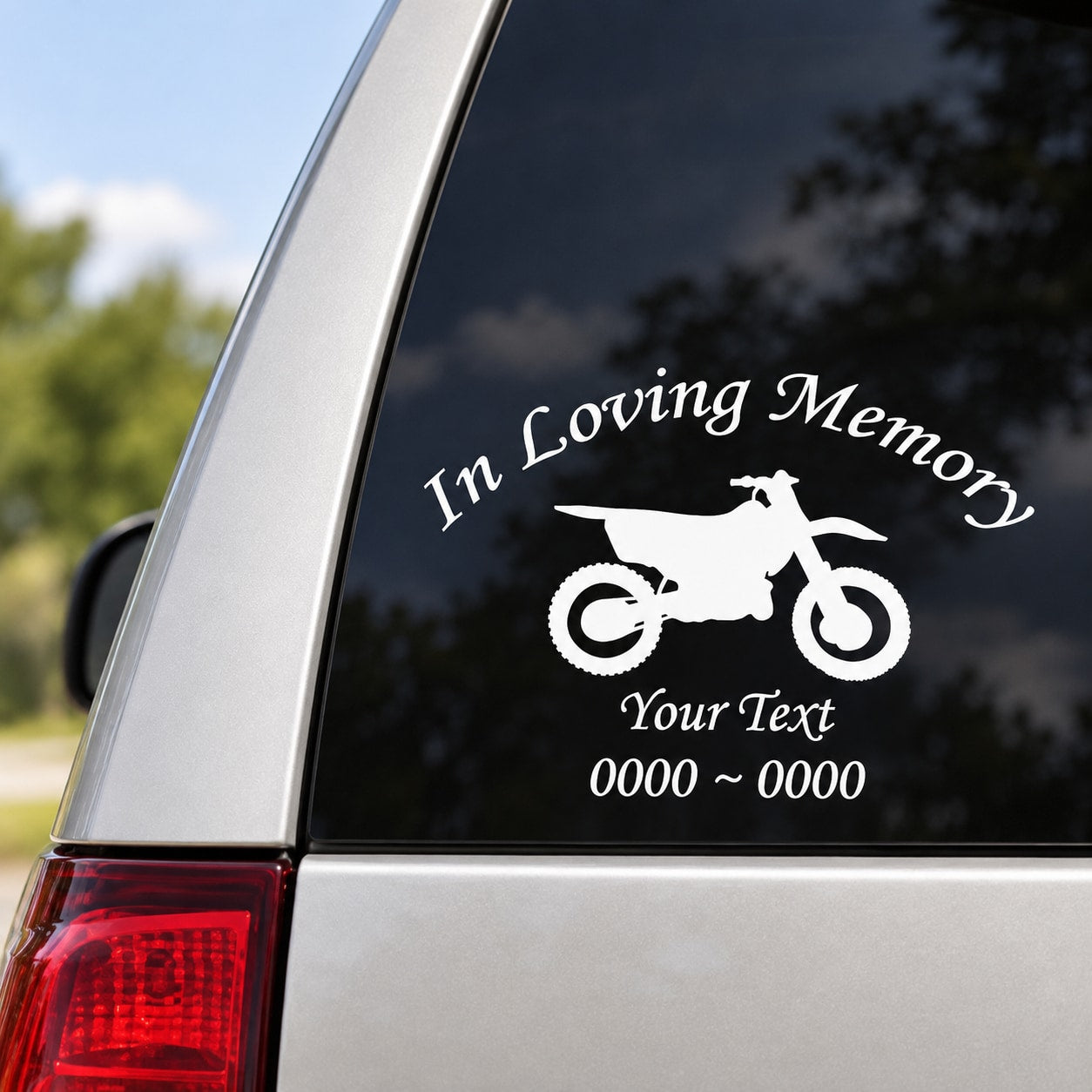 Custom dirt bike memorial decal with white text and motorcycle silhouette on black