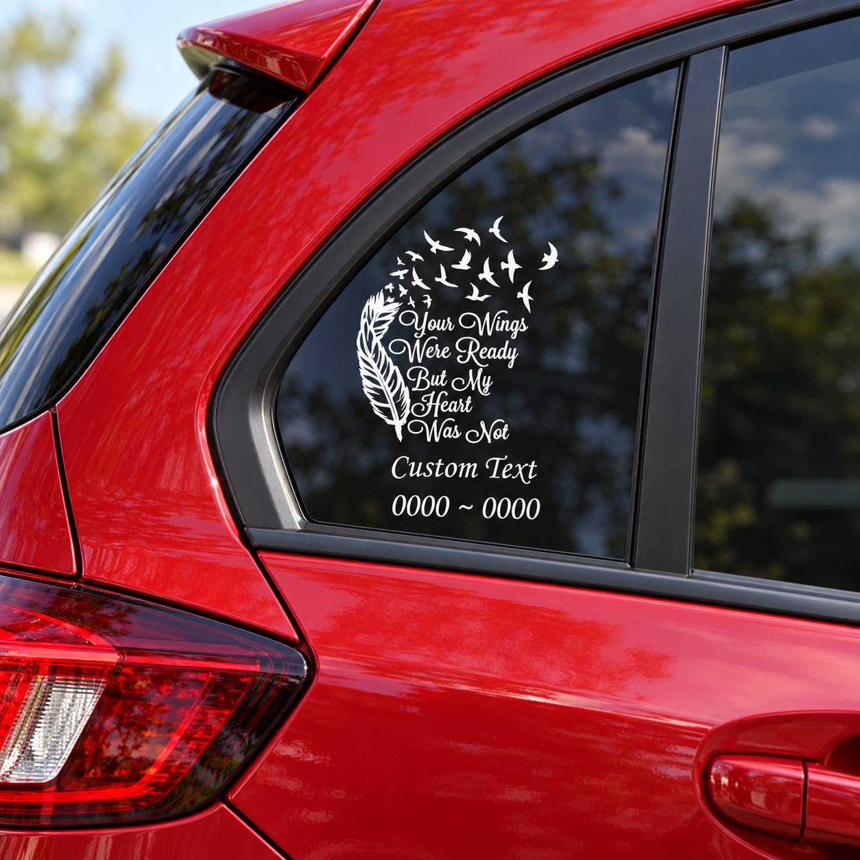 White memorial bird and feather decal with quote text on car window