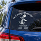 Car window decal with “In Loving Memory” text and flower graphic