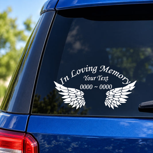 White memorial lettering sticker with wings graphic and custom text on dark window