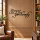 Black cursive wall decal reading “The essence of pleasure is spontaneity”.