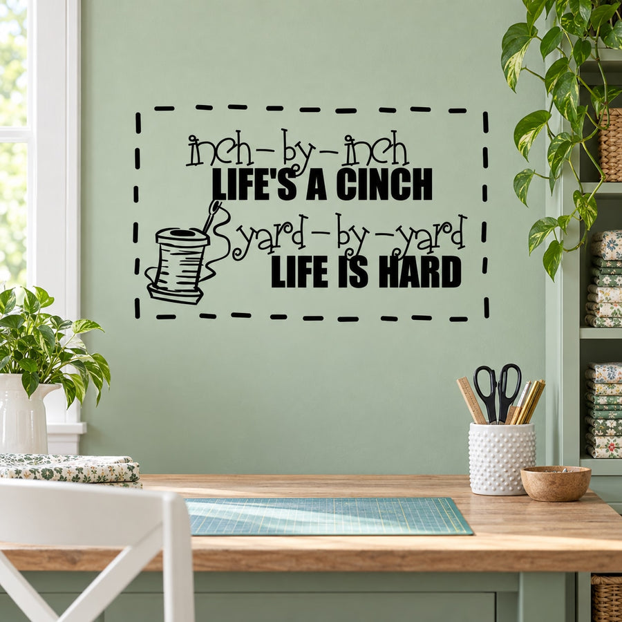 Sewing quote wall decal with spool icon and text: Inch by inch... yard by yard
