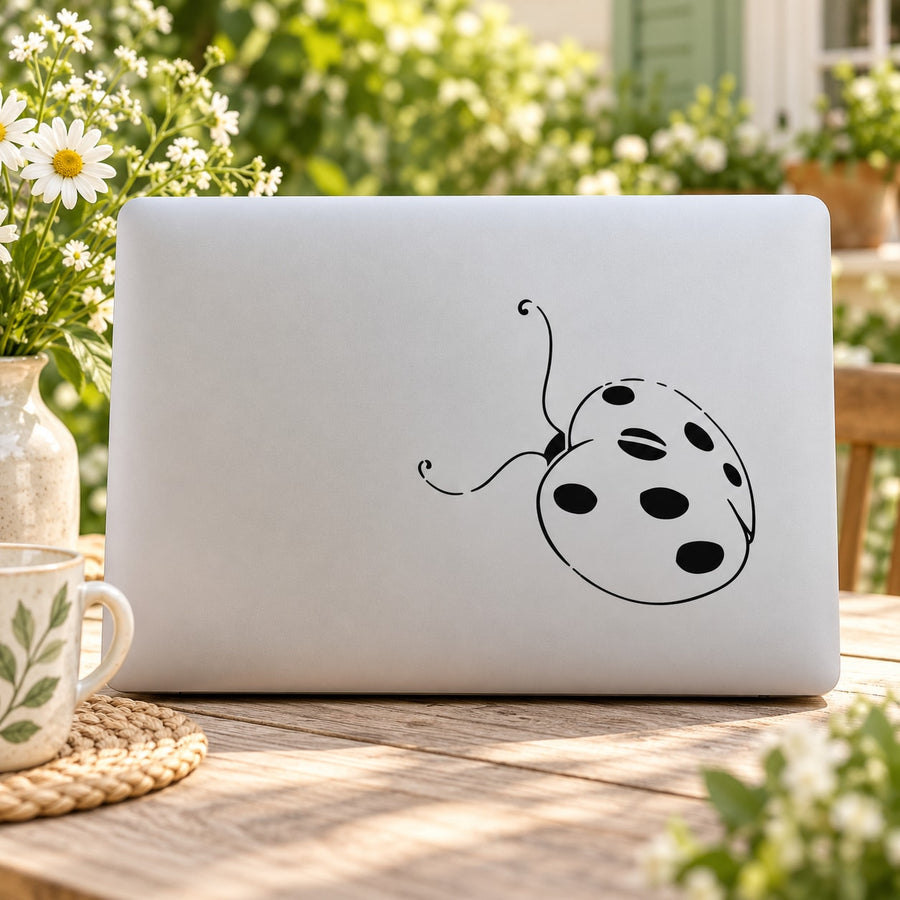 Ladybug decal featuring a black-and-white cartoon ladybug on a light panel