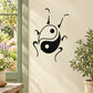 Yin-yang insect wall decal with black linework and two circular eye dots