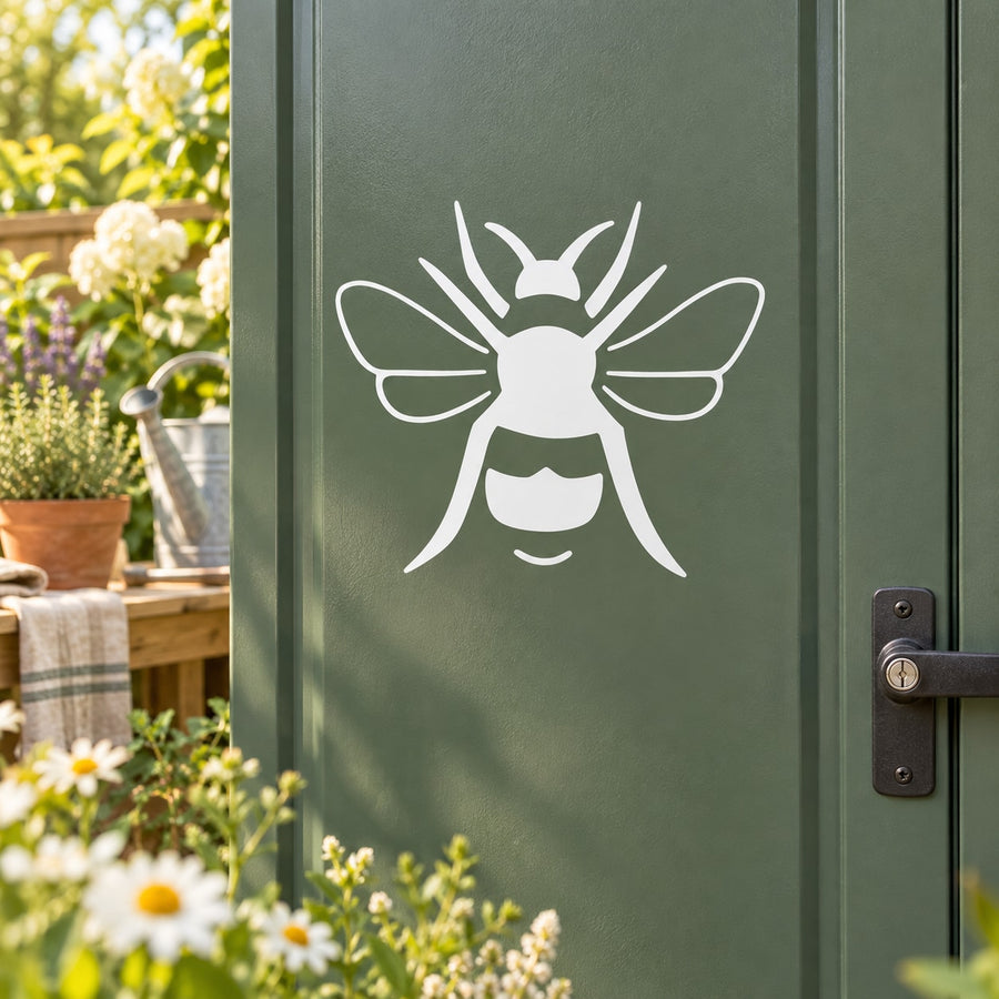 White bumble bee line-art decal on a dark green surface