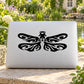 Dragonfly wing swirl decal in black on white rectangular surface