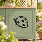 Ladybug wall decal with black outline and spots on light surface