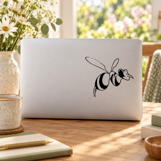 Hornet decal with black line-art design on a light laptop lid