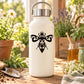 White bottle with black swirl winged bug decal on front