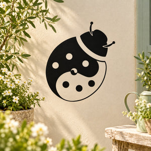 Yin-yang ladybug decal, black and cream with white dots and antenna on beige