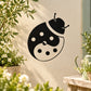 Yin-yang ladybug decal, black and cream with white dots and antenna on beige