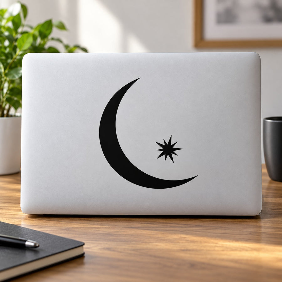 Black crescent moon and star decal on white laptop