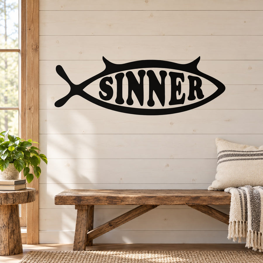 Black fish-shaped decal with bold white “SINNER” lettering