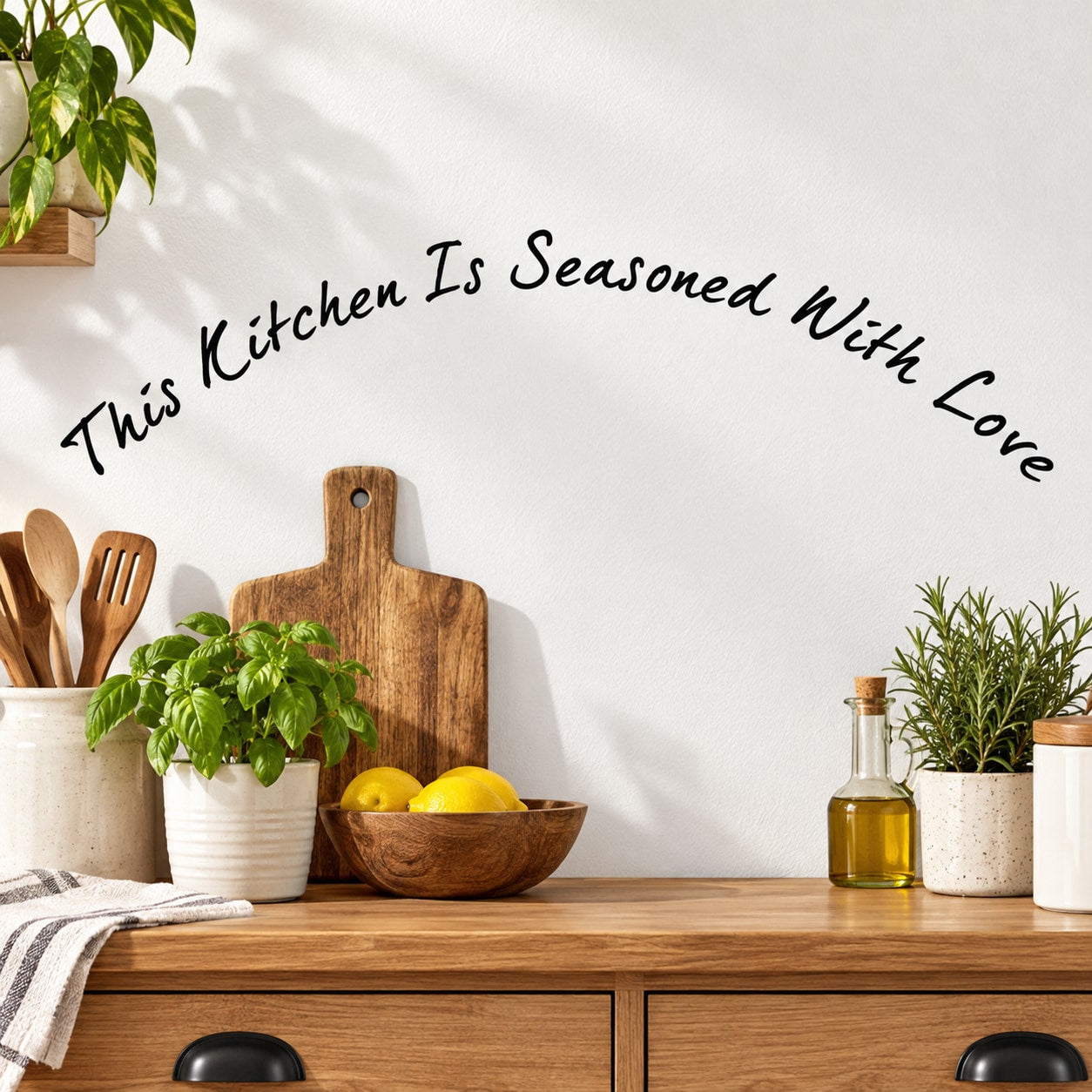 Kitchen wall decal reading “This Kitchen Is Seasoned With Love” in black cursive