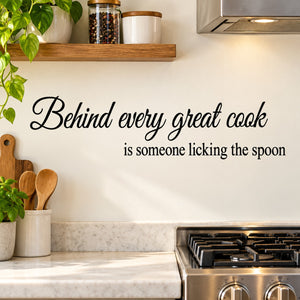 Wall decal with cursive quote: Behind every great cook is licking the spoon