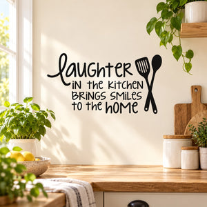 Kitchen wall decal with cursive text and fork/spoon icons, “Laughter in the Kitchen”