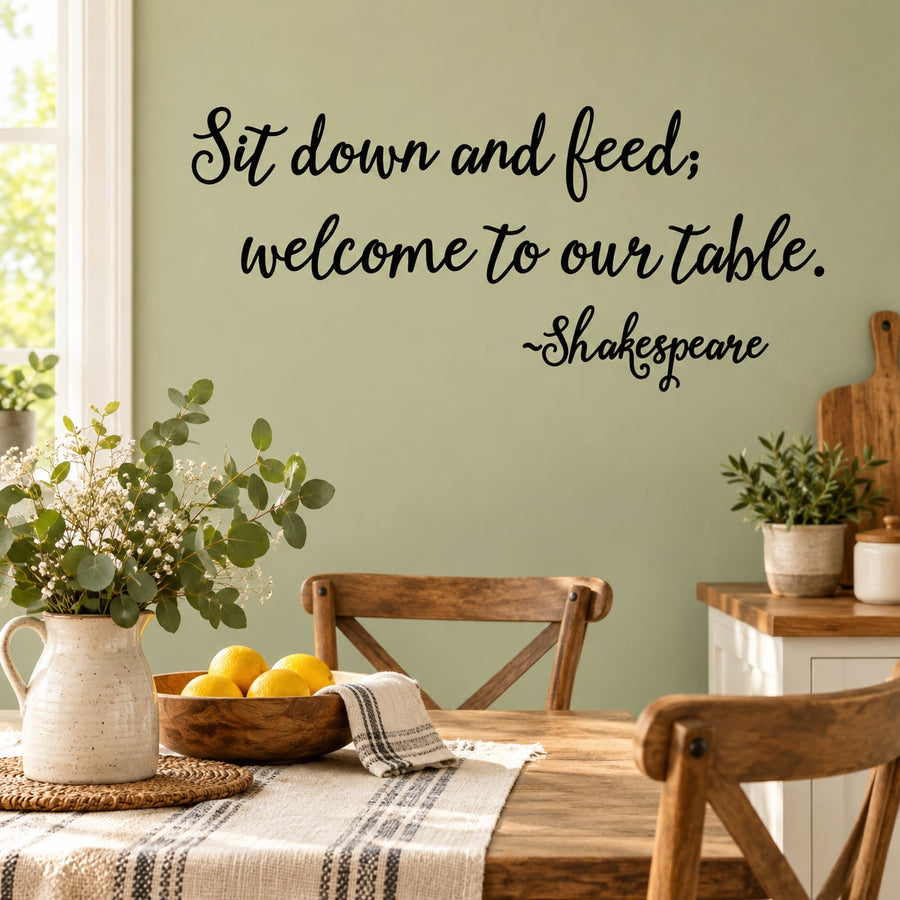Black cursive wall decal text: 'Sit down and feed, welcome to our table'
